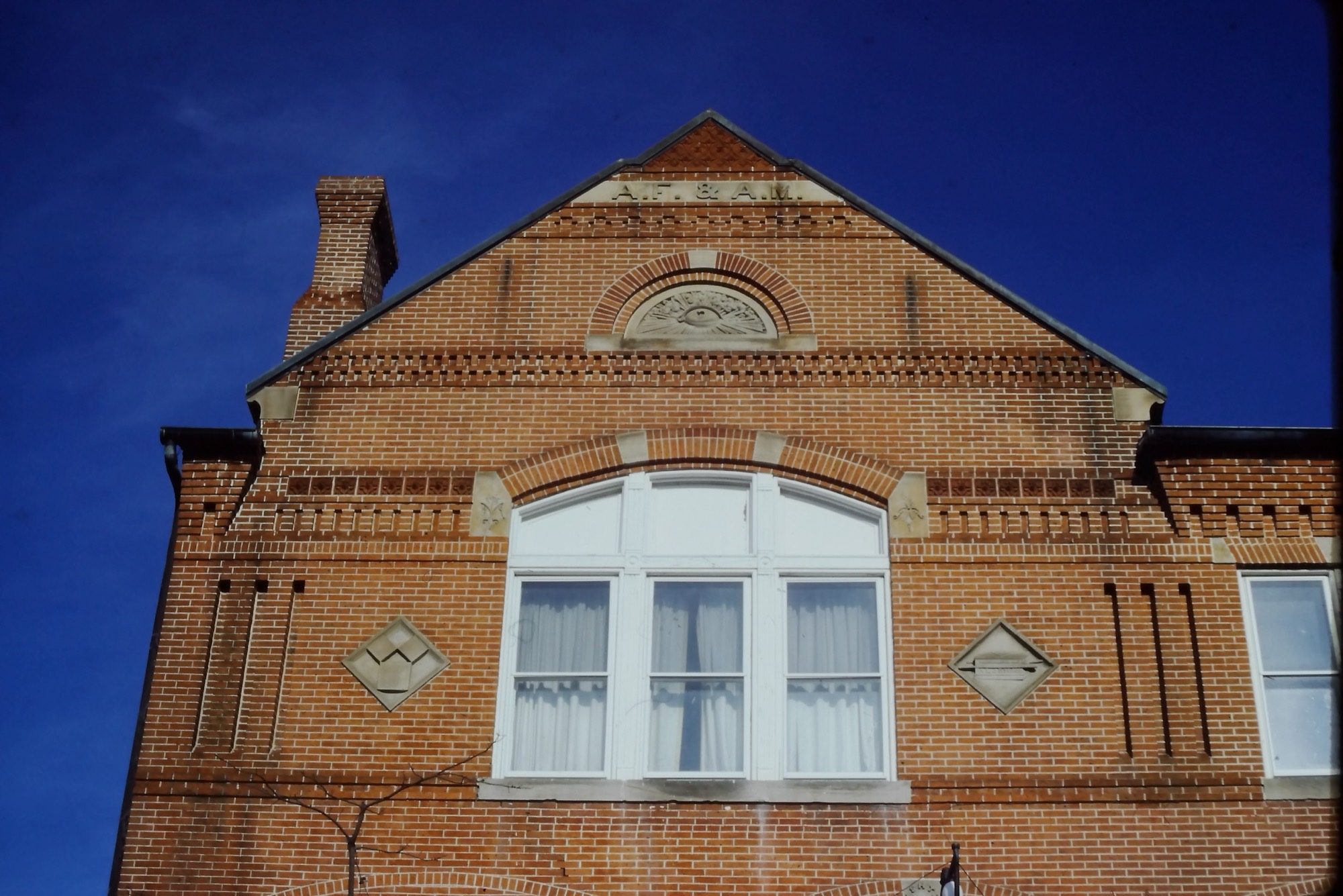 The brick gable of the Masonic Temple in Easton, Maryland, against a deep blue sky
